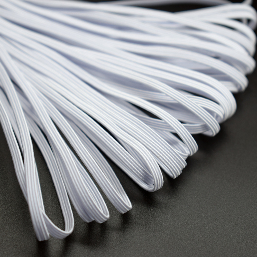 Close-up of white braided elastic band showing braided texture
