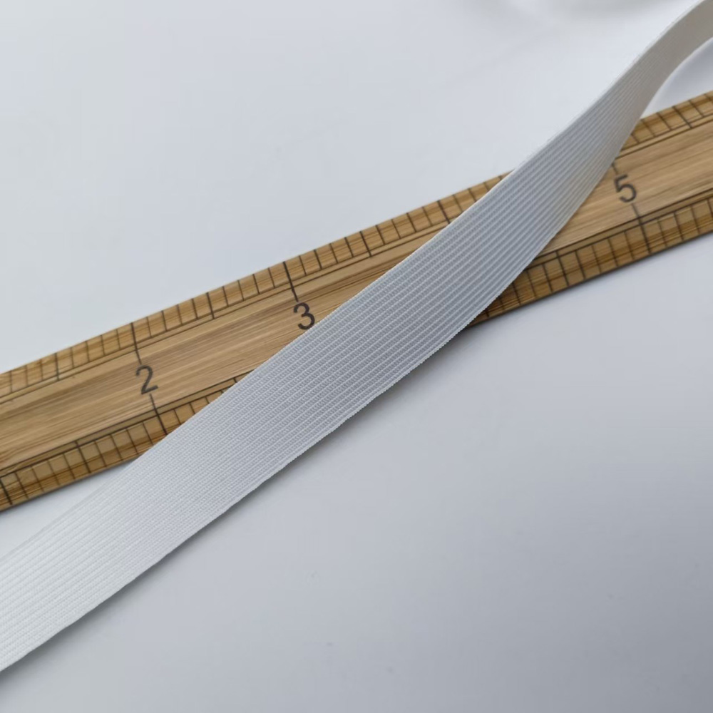 Crochet-knit elastic band laid against a ruler to show band width