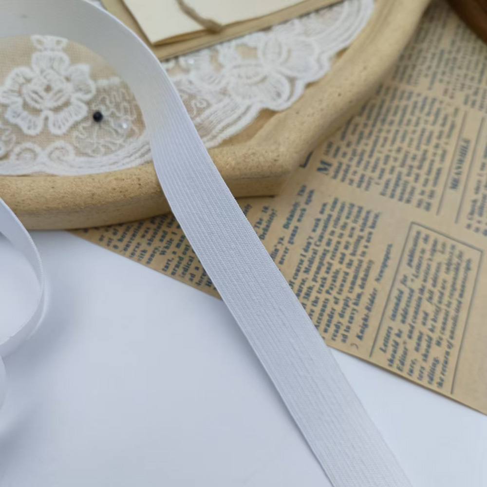 White crochet-knit spandex elastic band with fine ribbed surface texture
