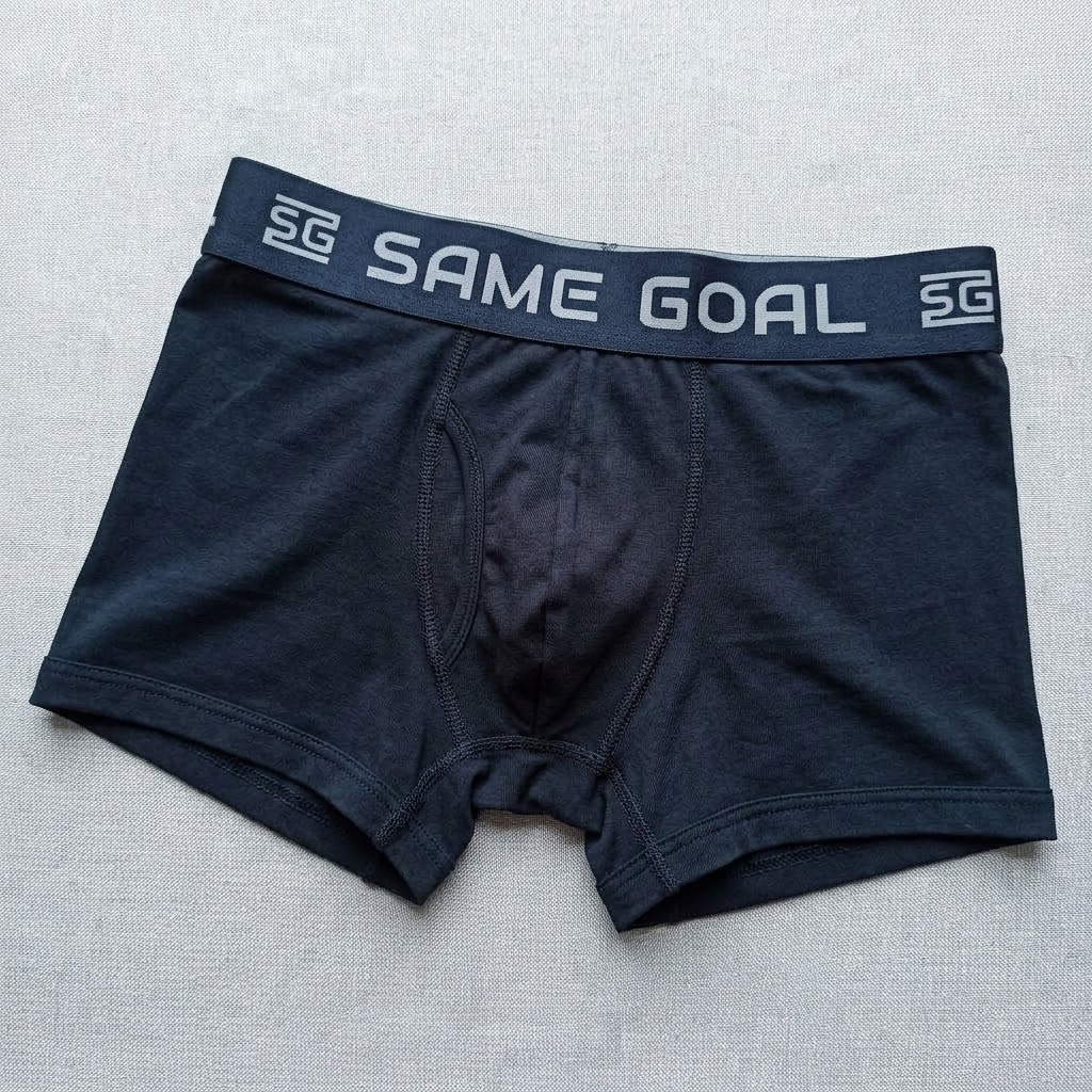 Finished men's boxer brief with a dark jacquard elastic waistband showing the woven SAME GOAL logo
