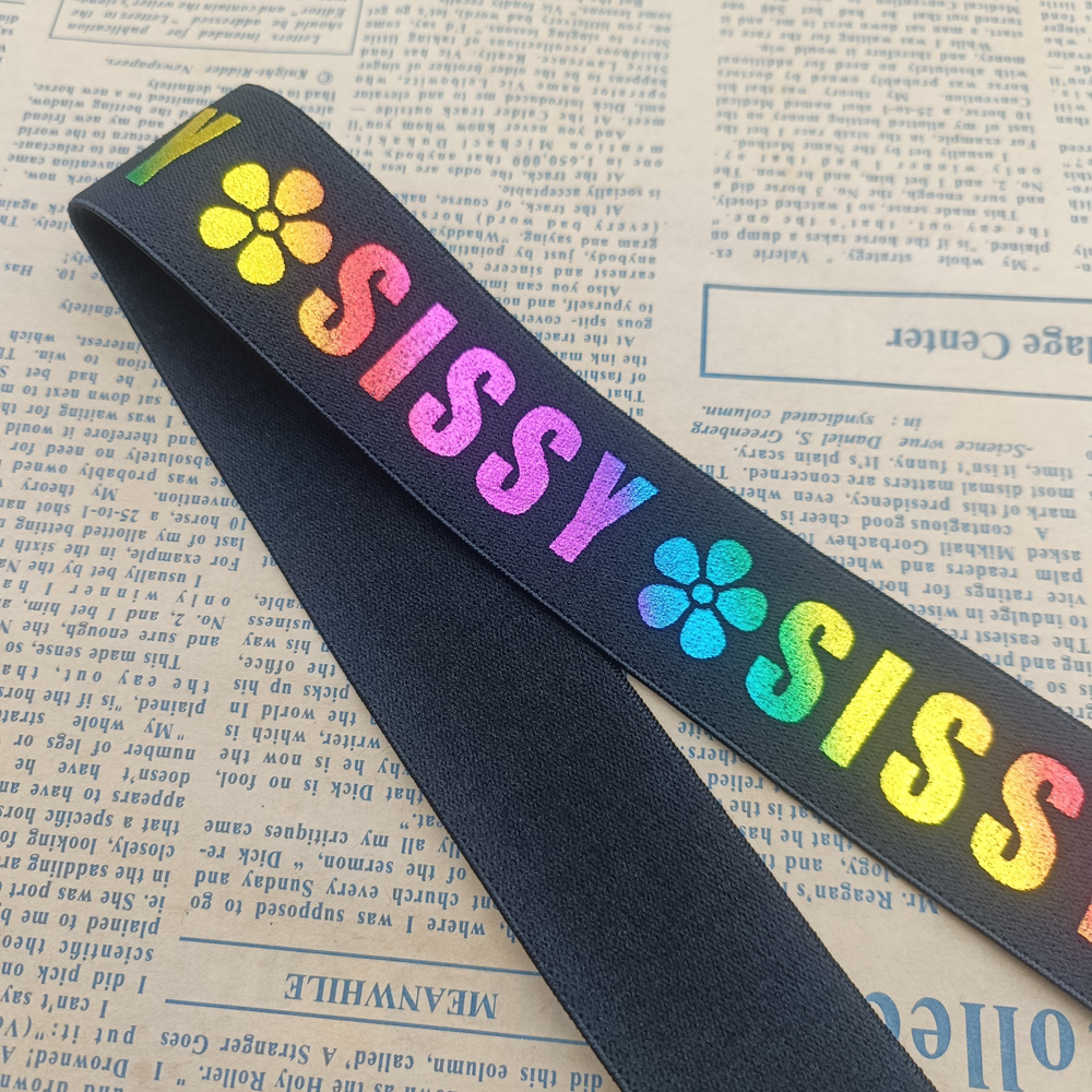 Close-up of rainbow gradient laser print on black nylon elastic band